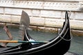 Two gondolas cross in a canal in Venice
