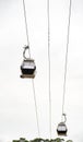 Two gondolas from the Vila Nova de Gaia neighborhood cable car suspended on the hanging cables from the Don Luis I Bridge to the Royalty Free Stock Photo