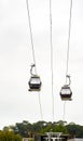 Two gondolas of the Vilanova de Gaia cable car suspended on the hanging steel cables under a cloudy white sky in Porto Royalty Free Stock Photo