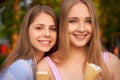 Two young ladies, best friends, holding ice cream