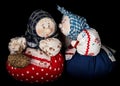 Two gossip girls share news, two women stand side by side, handmade rag dolls, isolated on black background Royalty Free Stock Photo