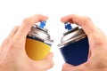 Two graffiti color spray cans in hands