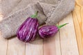 Two graffiti eggplants on the rustic table Royalty Free Stock Photo