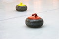 Two granite stones for curling game on the ice Royalty Free Stock Photo