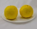 Two Grapefruits on a Plate