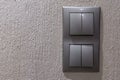 Two gray double light switches mounted on the wall Royalty Free Stock Photo