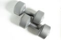 A Two gray dumbbell with round weights and a cylindrical handle Royalty Free Stock Photo