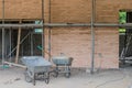 Wheelbarrows in front of red brick wall