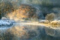 Peaceful misty morning in the English Lake District National Park with Autumn colours reflecting in still calm river. Royalty Free Stock Photo