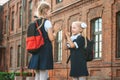 Two great Schoolgirls give each other five. First day of study. Concept on the topic Back to School.