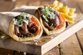 Two greek gyros with shaved lamb and french fries Royalty Free Stock Photo
