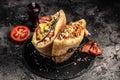 Two greek gyros wrapped in pita breads with grilled meat, vegetables and sauce on dark background. banner, menu, recipe place for Royalty Free Stock Photo