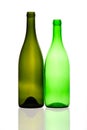 two green bottles and its reflections on a white background Royalty Free Stock Photo