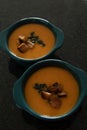 Two green bowls with butternut soup