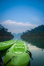 Two green canoes in the lake on twillight time. Royalty Free Stock Photo