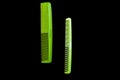 Two green combs on a black background, isolate Royalty Free Stock Photo