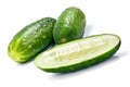 Two green cucumbers and half cut along close-up isolated on white background Royalty Free Stock Photo