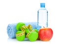 Two green dumbells, tape measure, apple and water bottle Royalty Free Stock Photo