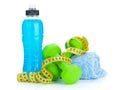 Two green dumbells, tape measure and drink bottle. Fitness and h