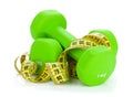 Two green dumbells and tape measure. Fitness and health