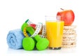 Two green dumbells, tape measure and healthy food. Fitness and h