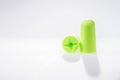 Two green ear plugs isolated on white Royalty Free Stock Photo