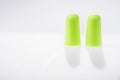 Two green ear plugs isolated on white Royalty Free Stock Photo