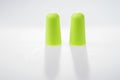 Two green ear plugs isolated on white Royalty Free Stock Photo