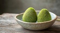 Two Green Egg-Shaped Desserts in a Rustic Bowl Royalty Free Stock Photo