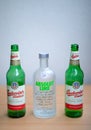 Two green empty Budweiser beer bottles and vodka Absolut Lime. Royalty Free Stock Photo