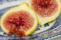 Two green fig halves with juicy red seeds. Royalty Free Stock Photo