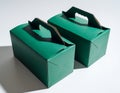 Two Green Gift Boxes with Handles on White Background Royalty Free Stock Photo