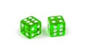 Two green glass dice isolated on white with a slight shadow. Six and four. Royalty Free Stock Photo