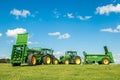 Two green John Deere tractors pulling bunning muck spreaders