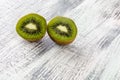 Two green kiwi halfs on  rustic background Royalty Free Stock Photo