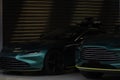 Two green luxury sportcars in the garage.