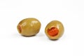 Two green olives stuffed with red pepper. Wet filled olives isolated Royalty Free Stock Photo