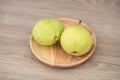 Two green pears in a wooden dish Royalty Free Stock Photo