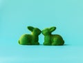 Two green rabbits in a kiss.