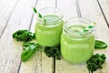 Green smoothies in mason jars against rustic white wood Royalty Free Stock Photo