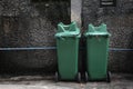 Two green trash near grunge wall Royalty Free Stock Photo