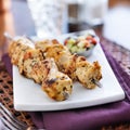 Two grilled chicken skewers