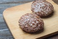Two grilled hamburger patty on cutting board Royalty Free Stock Photo