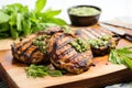 two grilled honey mustard pork chops with green herb dressing