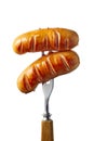 Two grilled sausages on fork over white background Royalty Free Stock Photo