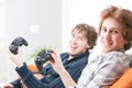 Two grinning teenage brothers holding joysticks