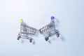 Two grocery baskets with colored handles on a light background. Royalty Free Stock Photo