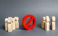 Two groups of people are divided by a red prohibition sign NO. prohibition, taboo, and rejection. Conservatism, misunderstanding Royalty Free Stock Photo