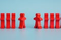 Two groups of wooden figures are standing in front of each other.  Two groups of toy people in the discussion. Conflict of Royalty Free Stock Photo