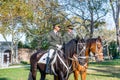 Two guards riding horses and wearing green uniform in the park Topkapi Palace in autumn, Istanbul, Turkey